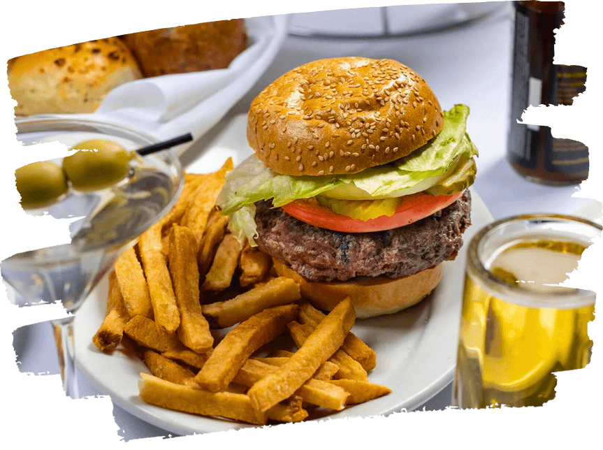 Sesame seed cheeseburger with fries, martini with olives, and a pint of beer.