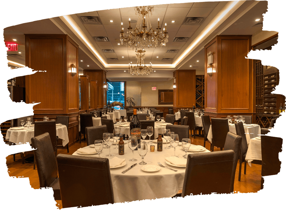 Elegant private dining room with chandeliers, white tablecloths, and wine displays